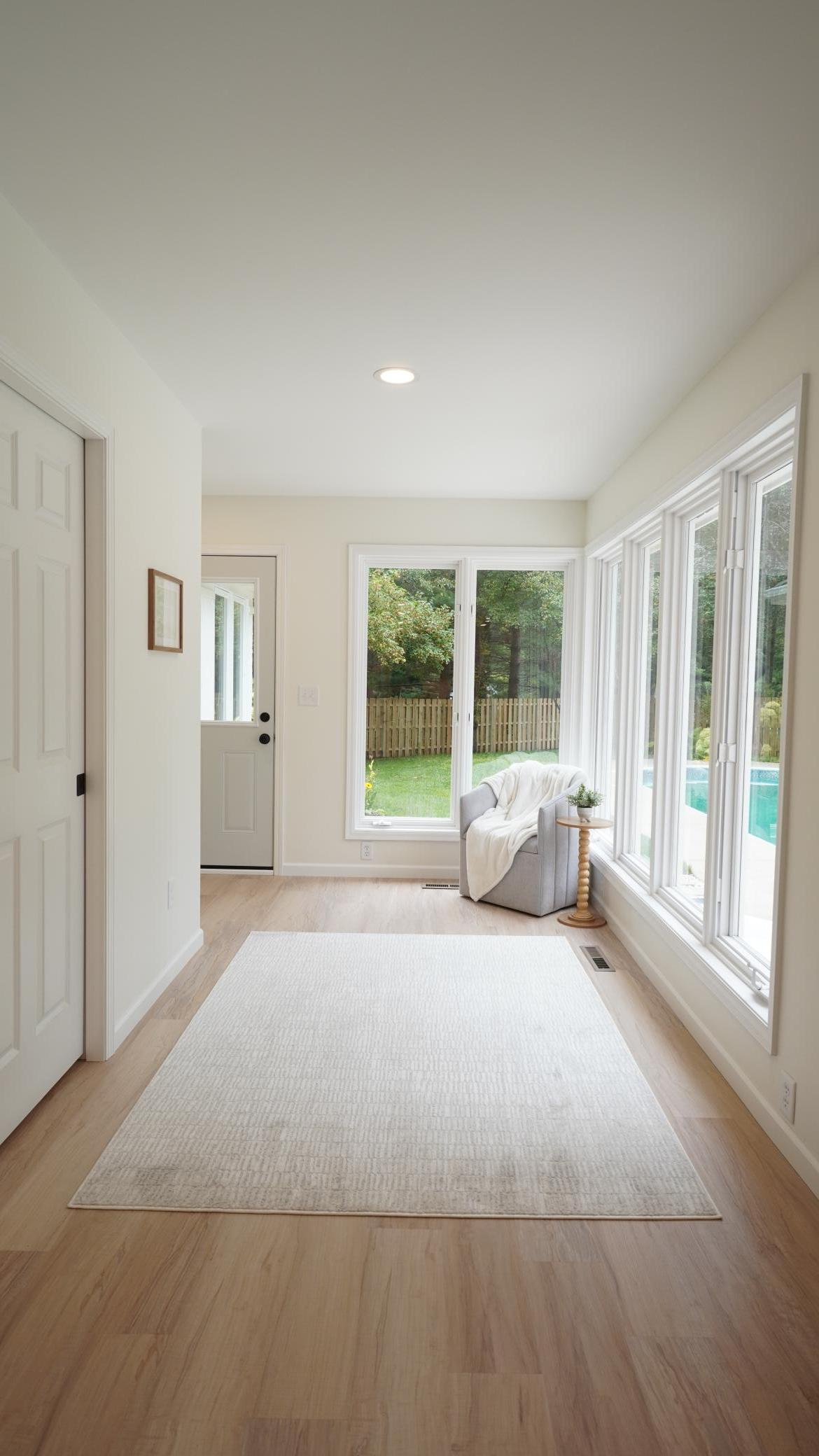 The sunroom, directly behind the eat-in kitchen with easy access to the pool, is filled with natural light and boasts the newly added Bathroom 3/ pool changing area behind the pocket door.