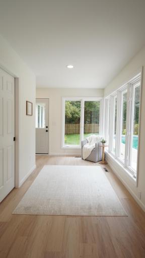 The sunroom, directly behind the eat-in kitchen with easy access to the pool, is filled with natural light and boasts the newly added Bathroom 3/ pool changing area behind the pocket door.