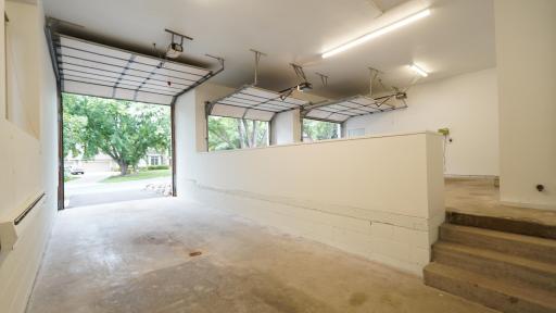 The oversized third garage stall has an extra tall overhead door with a 10' wide opening and floor drain. The 33' x 12' third stall is long enough for an RV, boat, or for two passenger cars, and tall enough for a car lift.