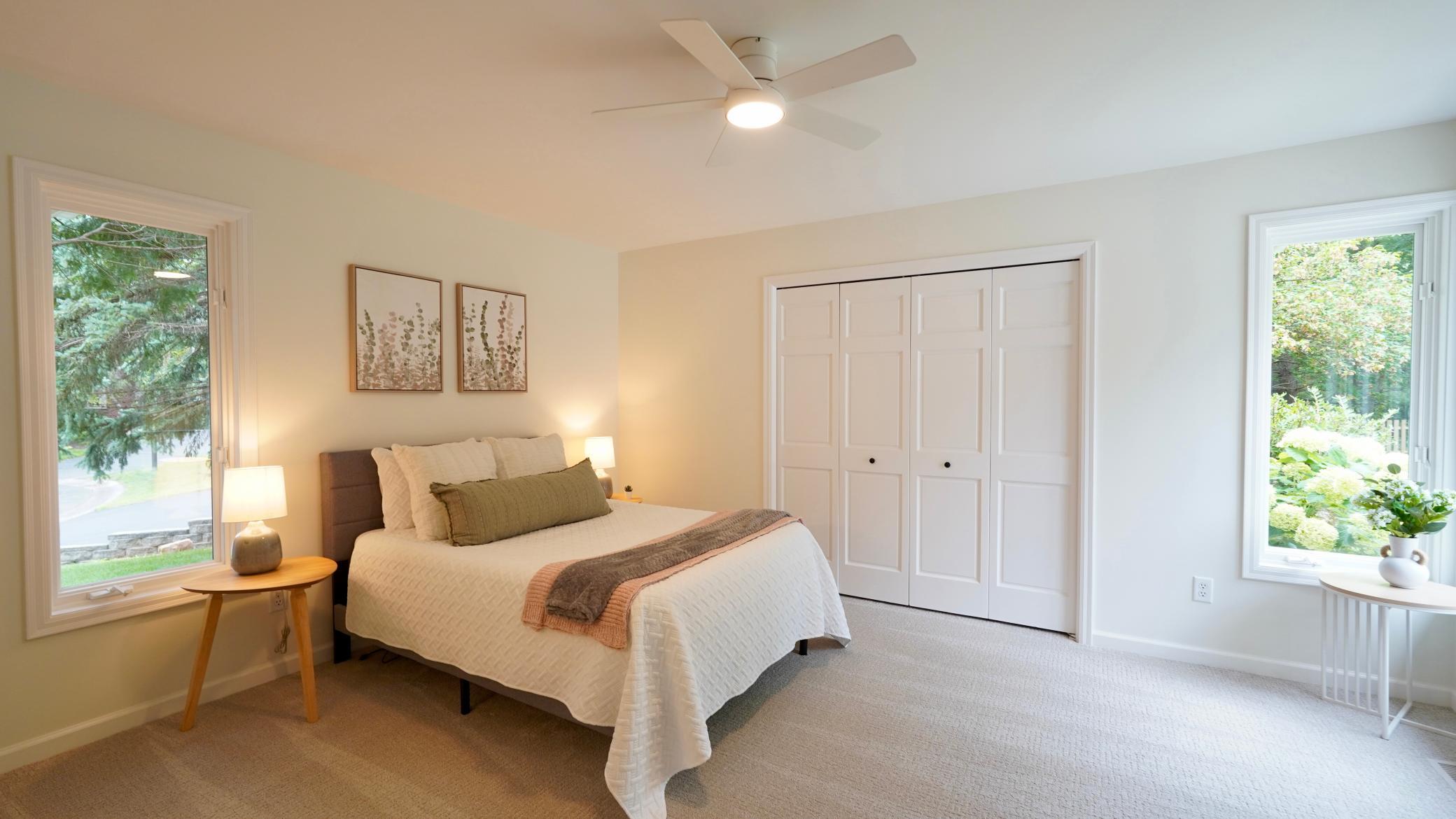 Bedroom 5 is filled with natural light from two sides, has views of the patio and pool area, and an oversized closet with a brand new closet system. It also features a new ceiling fan, carpet and fresh paint.