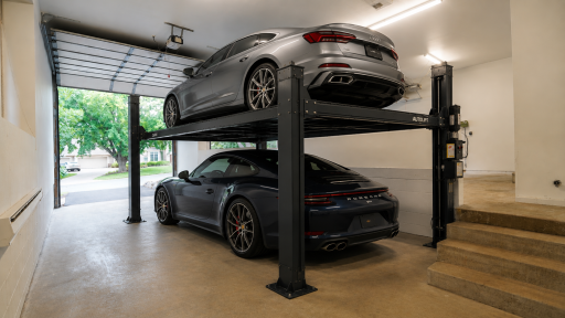 The oversized third garage stall is virtually staged with a car lift to generally show the large capacity and one potential use of this versatile space.