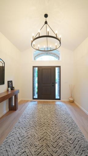 The considerable, vaulted front foyer makes a wonderful first impression with such elements as the brand new front door, flooring, paint and the 12-light chandelier overhead.