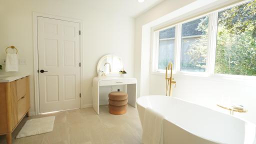The spacious primary en-suite bath includes a separate soaking tub and ample space for a makeup vanity.