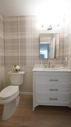 The brand new powder room between bedrooms 1 and 2 is beautifully appointed with wallpaper, a new vanity and new fixtures.