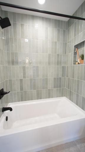 The brand new tub in the Jack and Jill bath features custom tile work in a gorgeous light sage color and new plumbing fixtures.