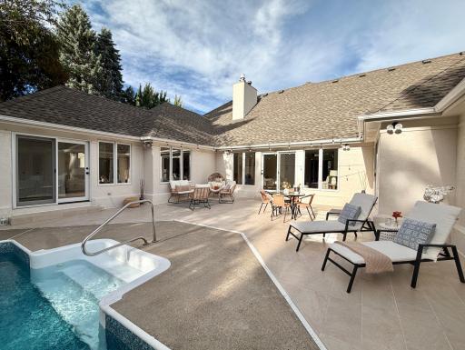 This home exemplifies indoor/ourdoor living with a U-shaped floor plan that wraps around a private courtyard with a generous, newly tiled patio and a fully enclosed back yard. Four rooms have direct access to this oasis.