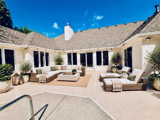 The generously sized patio is virtually staged in early afternoon full sun with a large sectional couch and oversized chaise lounges. This alternative shows there is ample room for a wide variety of furniture and uses.