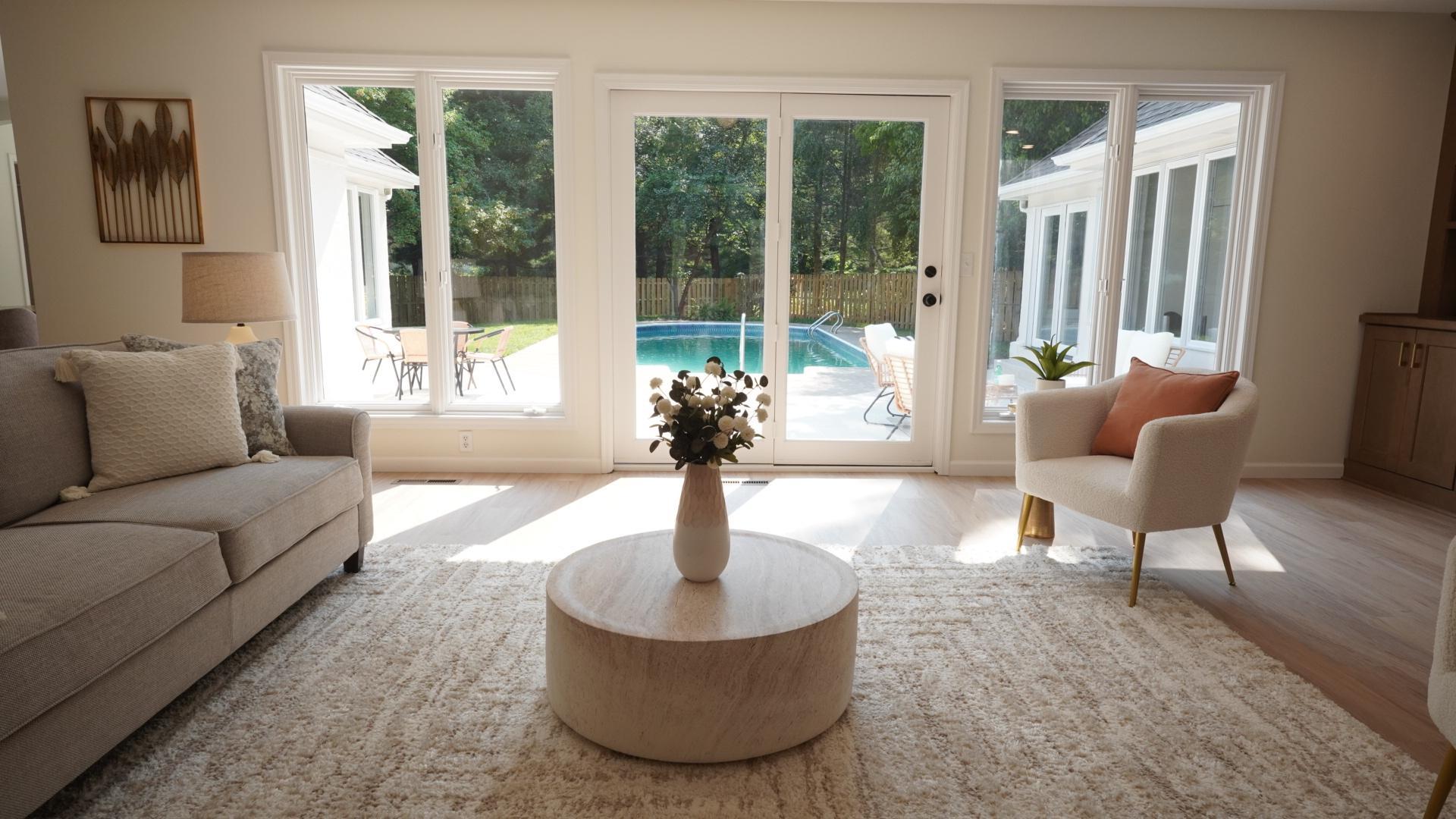 The light and bright, southwest facing living room adjacent to the kitchen has easy access to the generous courtyard with a large tiled patio, pool, and private backyard with mature trees enclosed by a new fence.