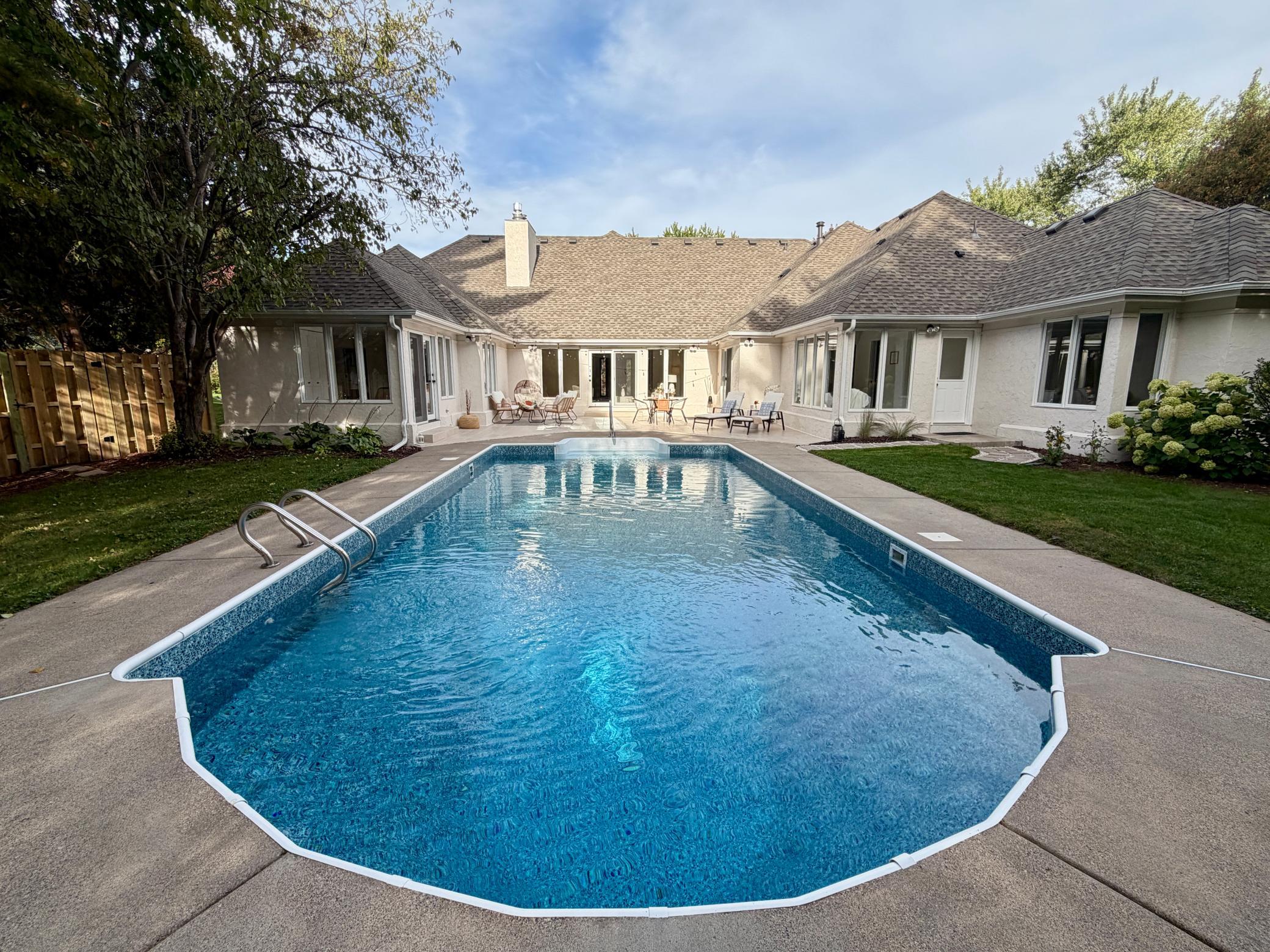 See the renovated pool before it is shut down for the season. The main level wraps around a private oasis with an updated pool, a large tile patio, and a fenced back yard. The pool has a brand new liner and a brand new filtration system.