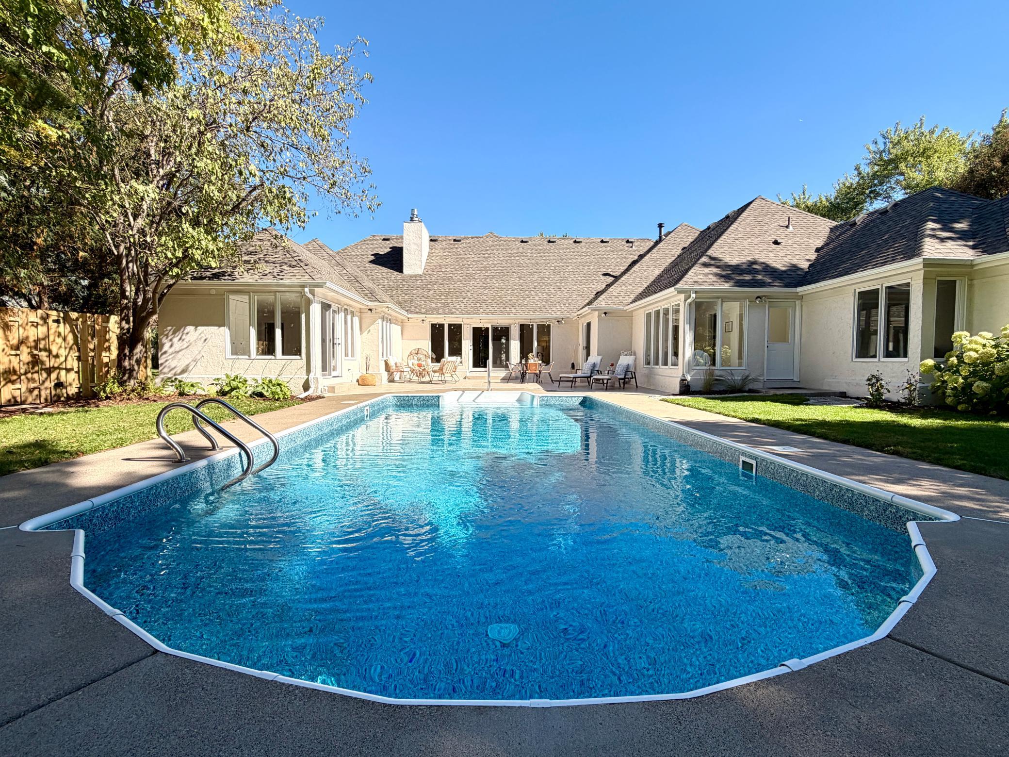 See the renovated pool before it is shut down for the season. The main level wraps around a private oasis with an updated pool, a large tile patio, and a fenced back yard. The pool has a brand new liner and a brand new filtration system.