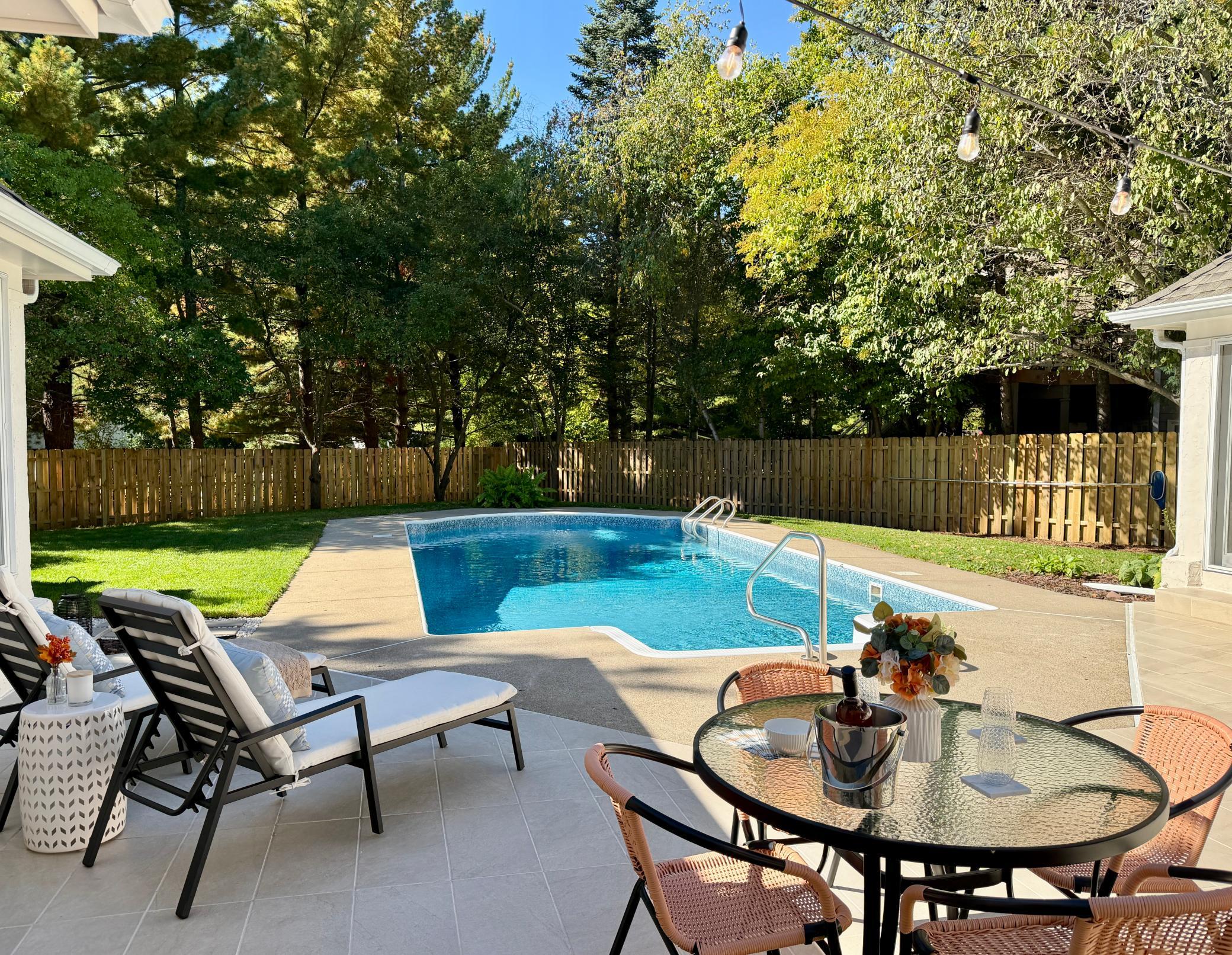 The patio is staged with three activity focal points next to the updated pool that has a new liner and a new filtration system. Mature tress provide privacy and shade. The flat back yard is a blank slate to customize with your personalized amenies.