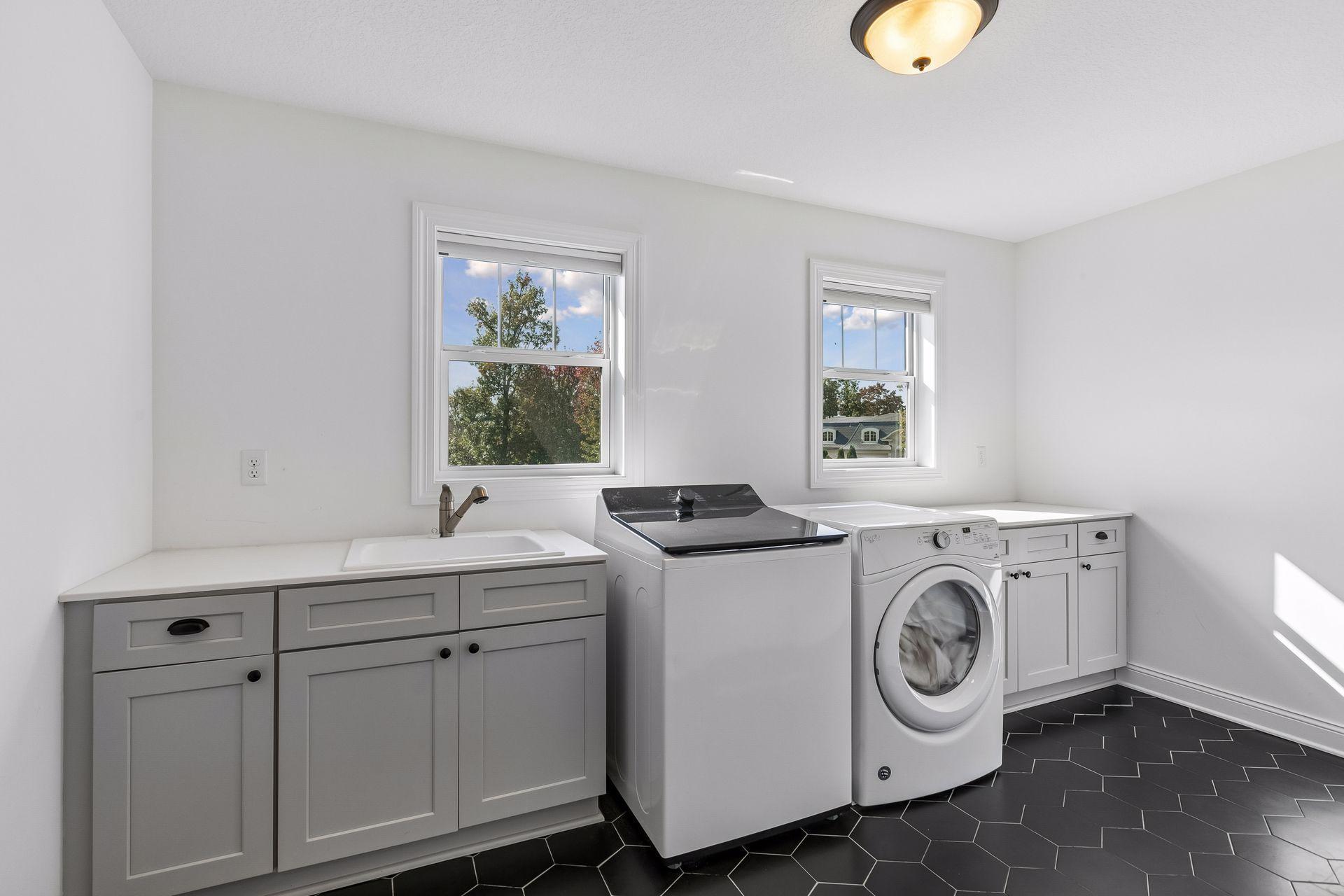 Convenient upper-level laundry room with direct access to the primary closet.