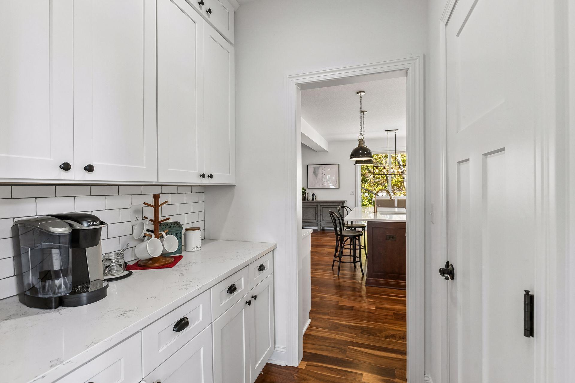 Coffee bar and pantry are thoughtfully tucked away for everyday convenience.