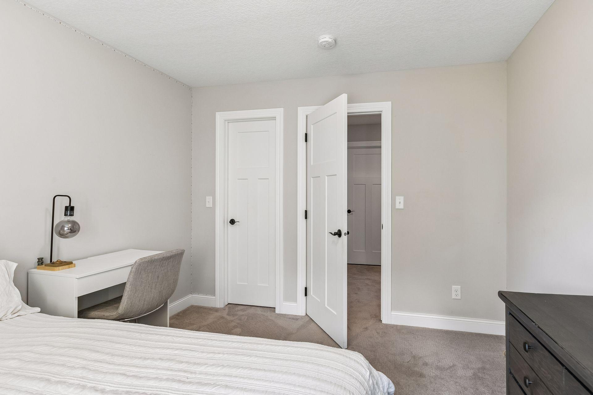 Fifth bedroom located on the lower level offers a comfortable space for guests.