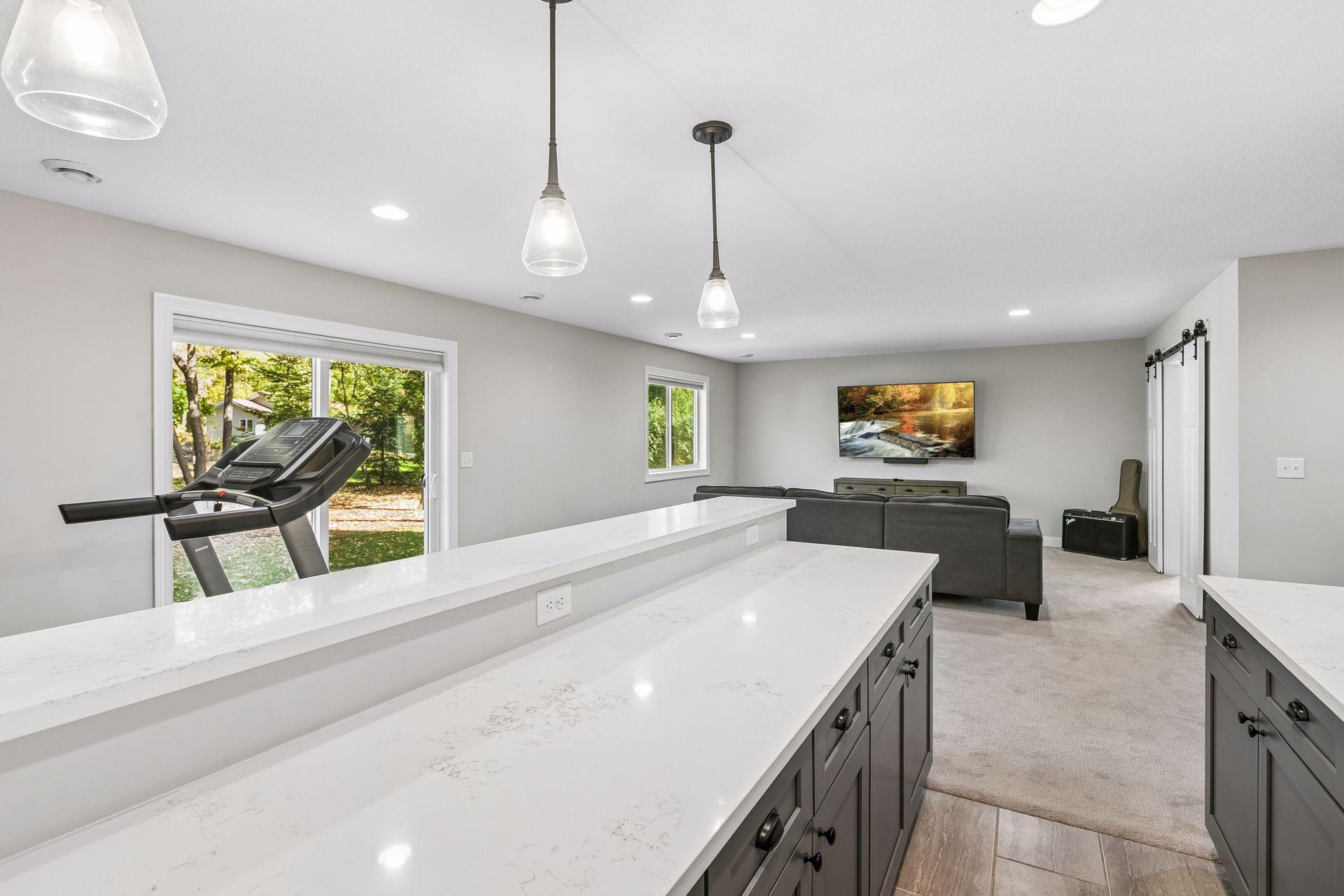 Lower-level bar area features sliding doors opening to the backyard.