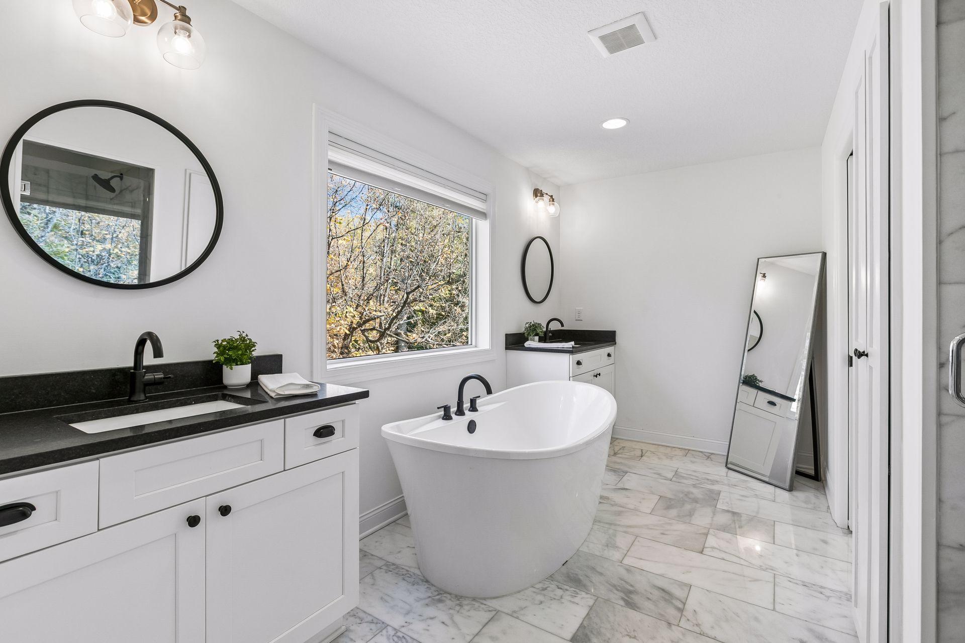 Primary bath features double vanities, a tub, a spacious walk-in shower and a private water closet.