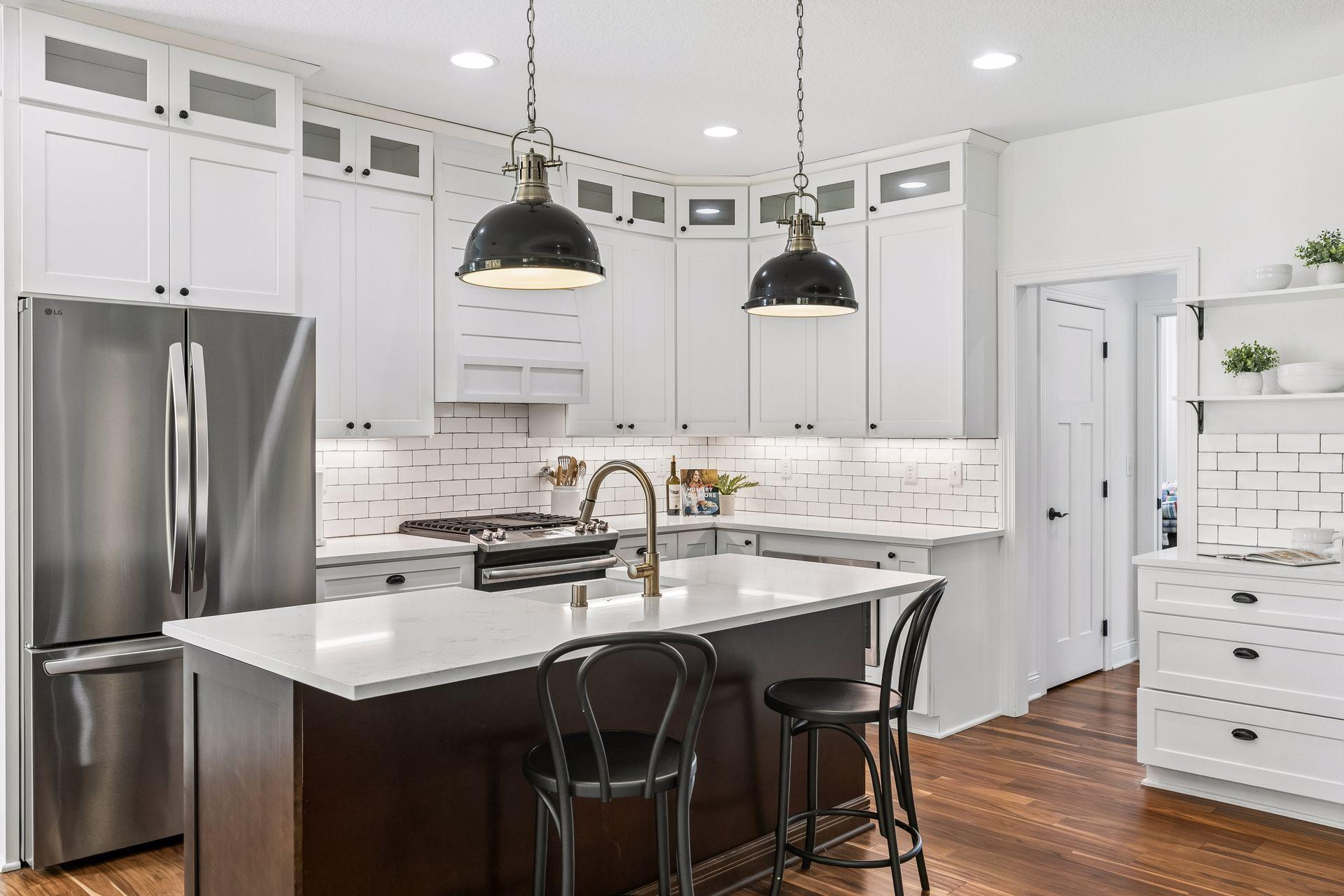 Beautiful white kitchen complemented by stainless steel appliances.