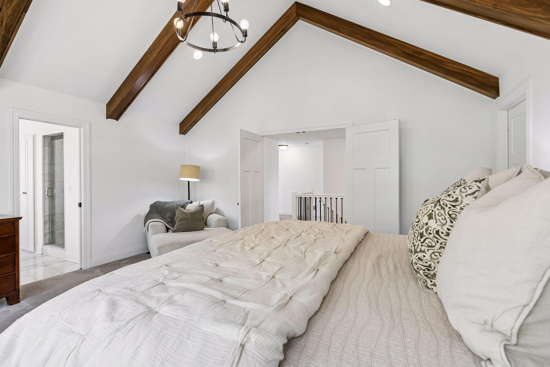 Double doors create a welcoming entrance to the primary bedroom.
