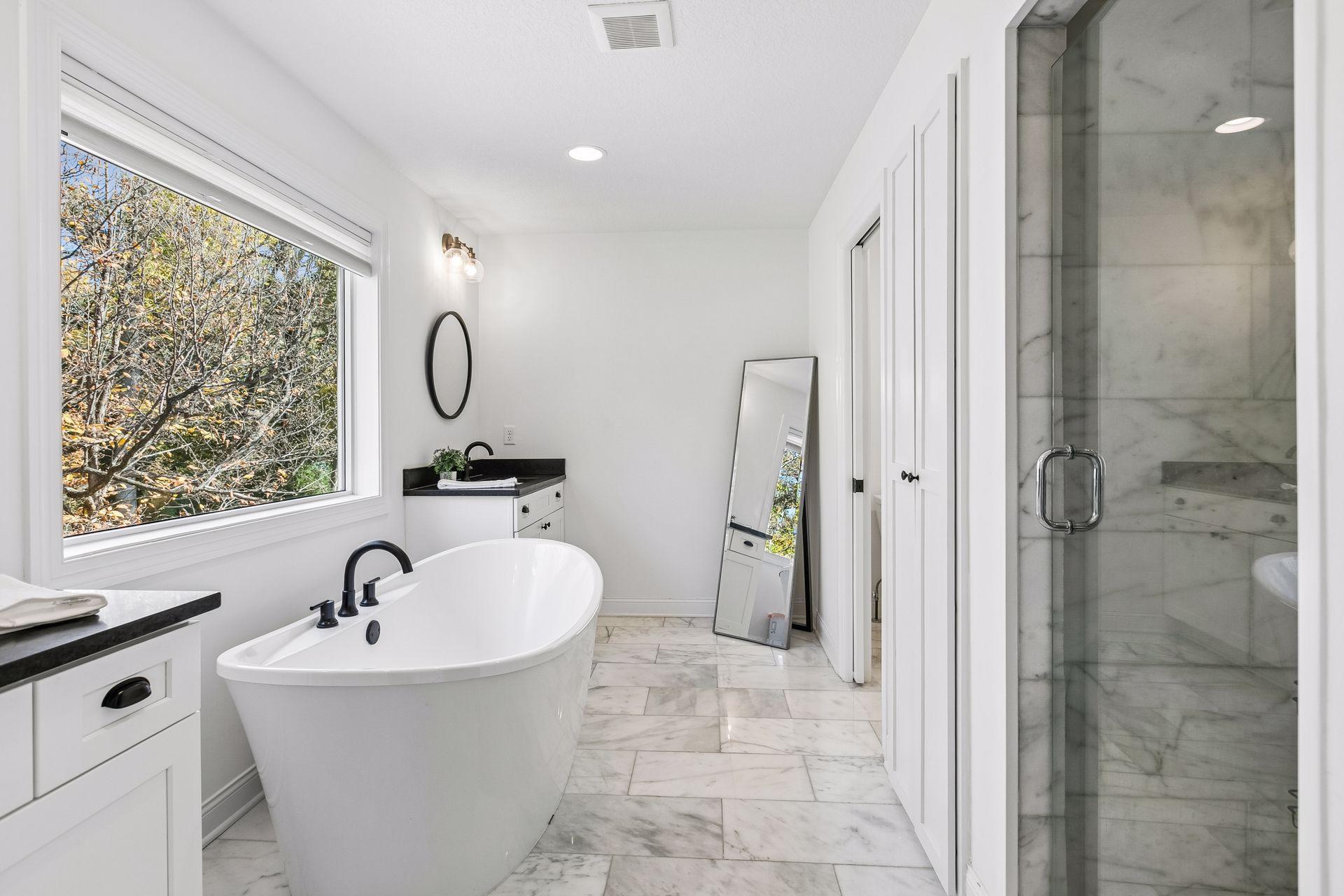 Primary bath features double vanities, a tub, a spacious walk-in shower and a private water closet.