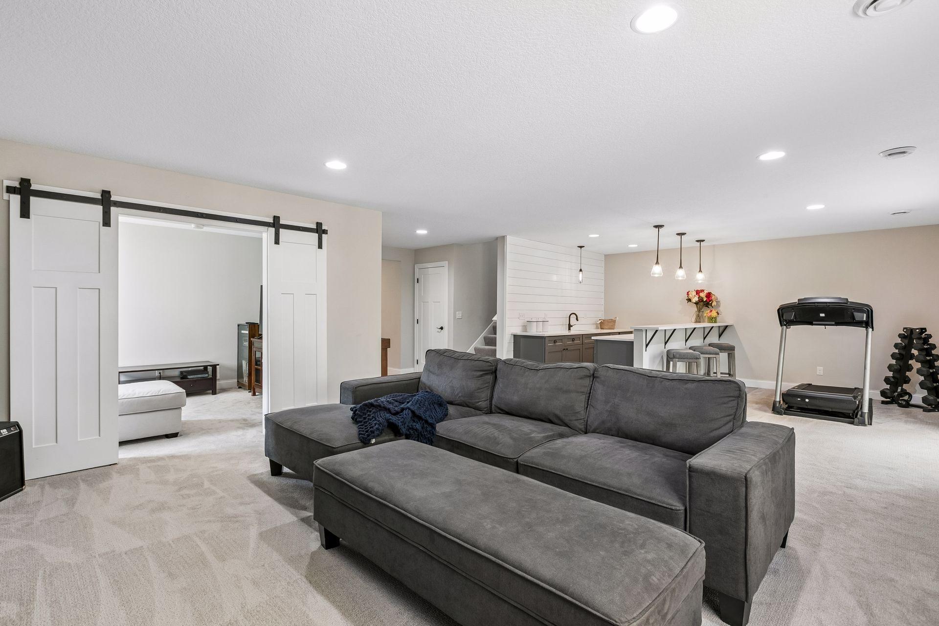 Lower-level family room opens to a flexible room for exercise, TV or gaming.