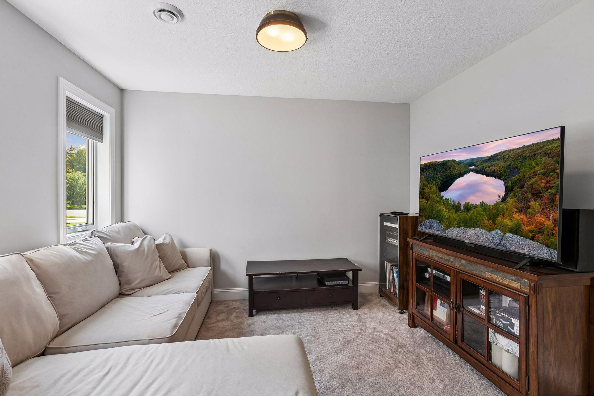 Flex room currently used for gaming offers versatile space for a playroom or exercise room.