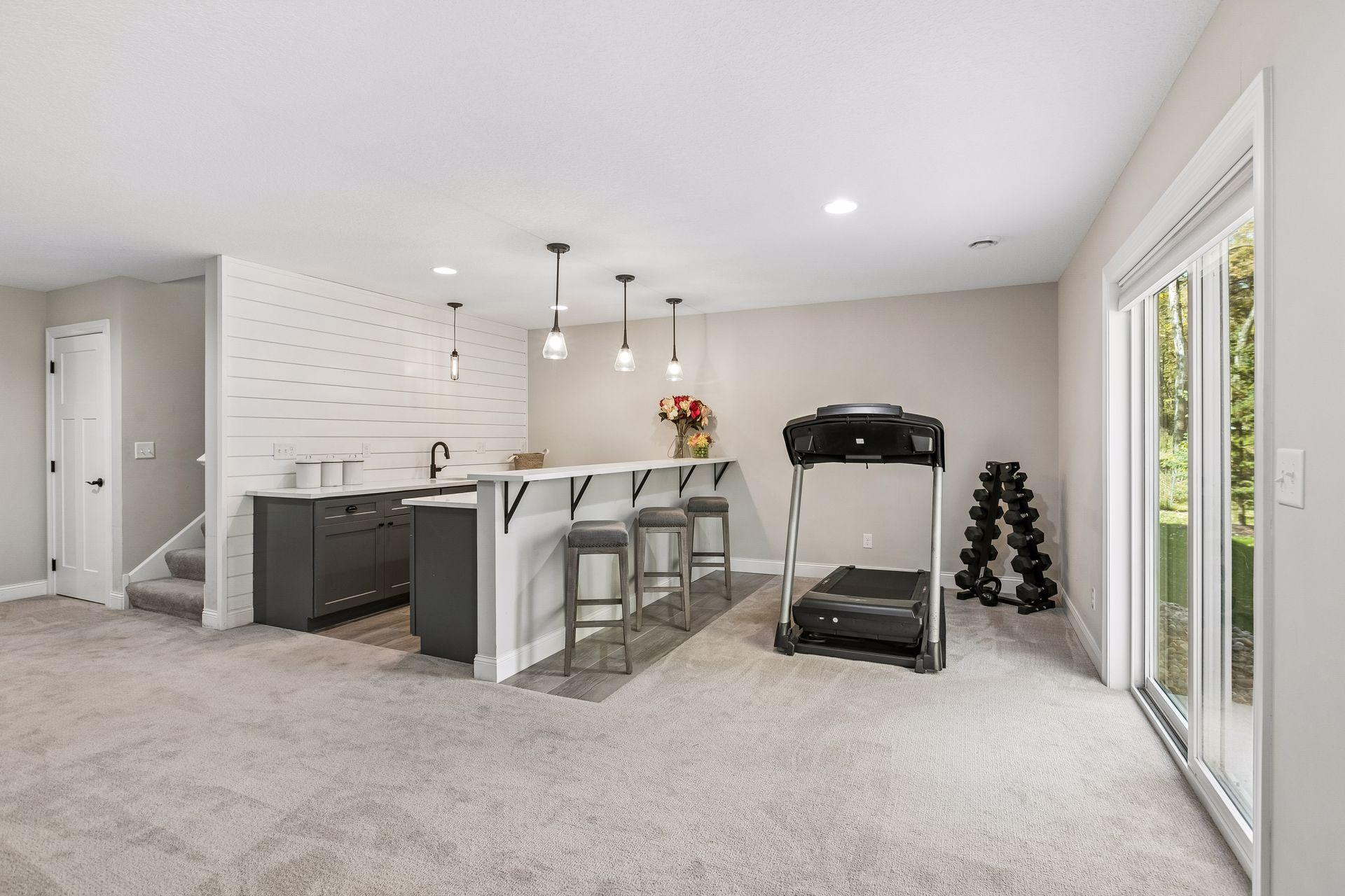 Lower-level bar area features sliding doors opening to the backyard.