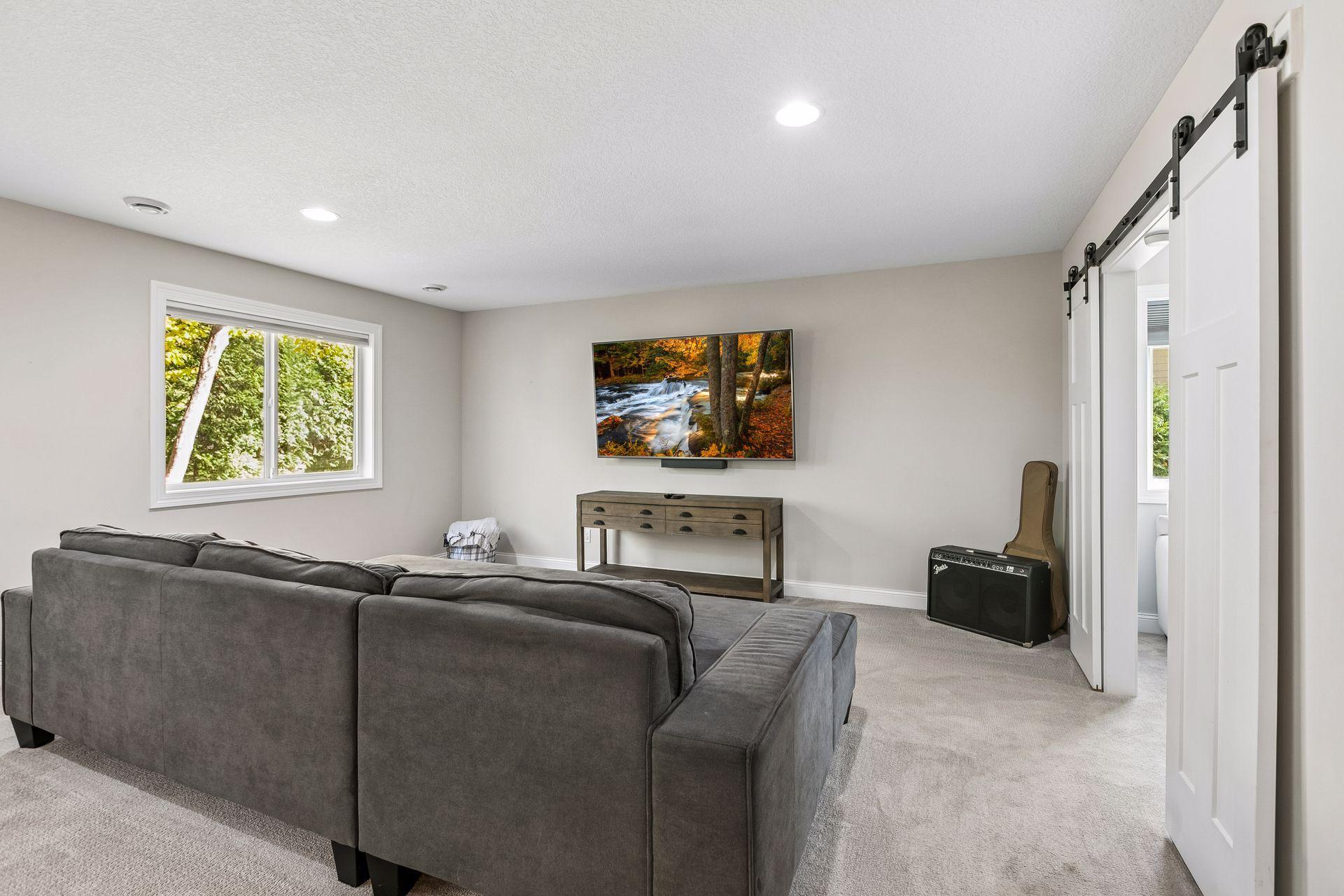 Spacious walkout lower-level family room offers an inviting space for entertaining.
