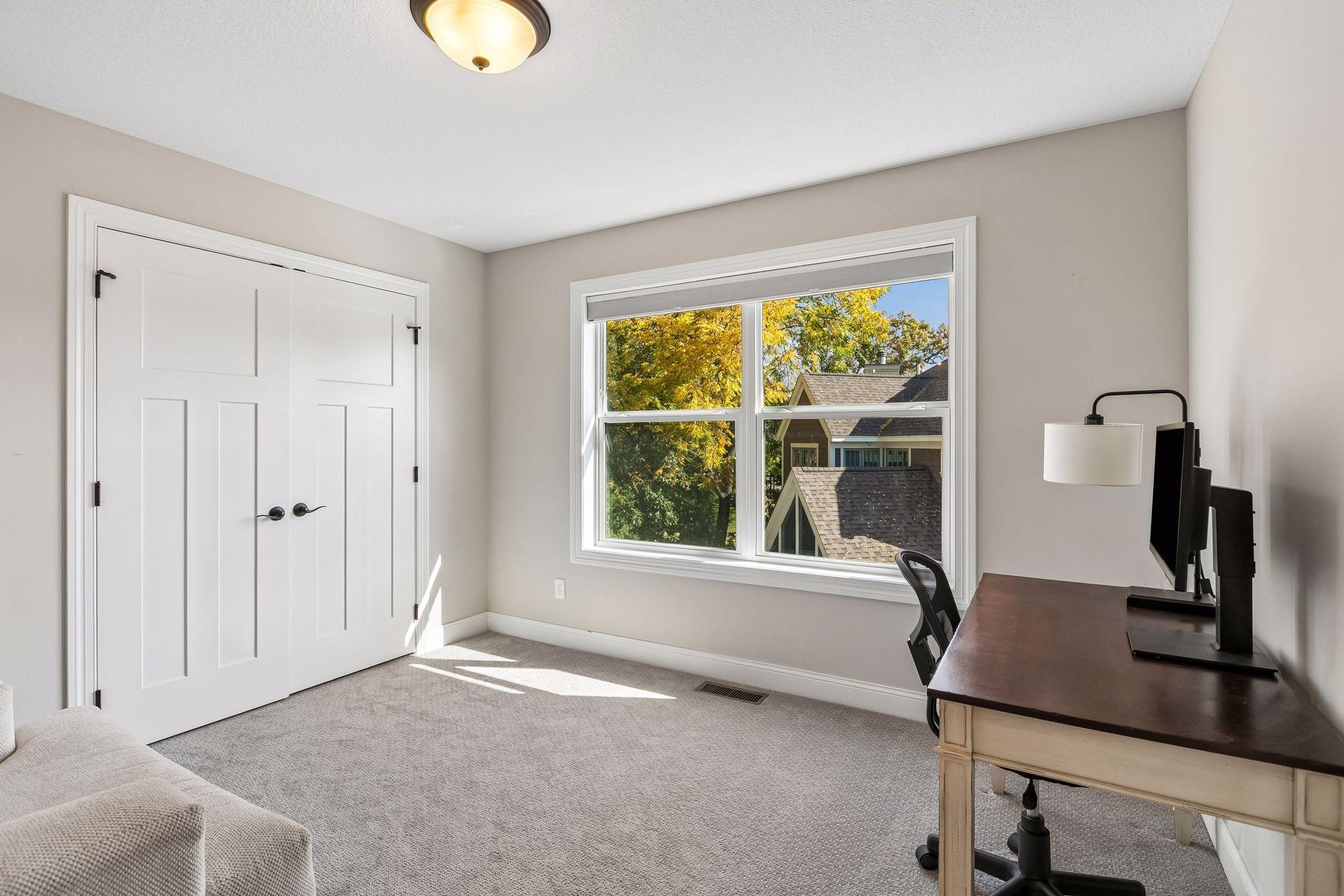 Bedroom four features a private ensuite bath and is currently used as a second home office.