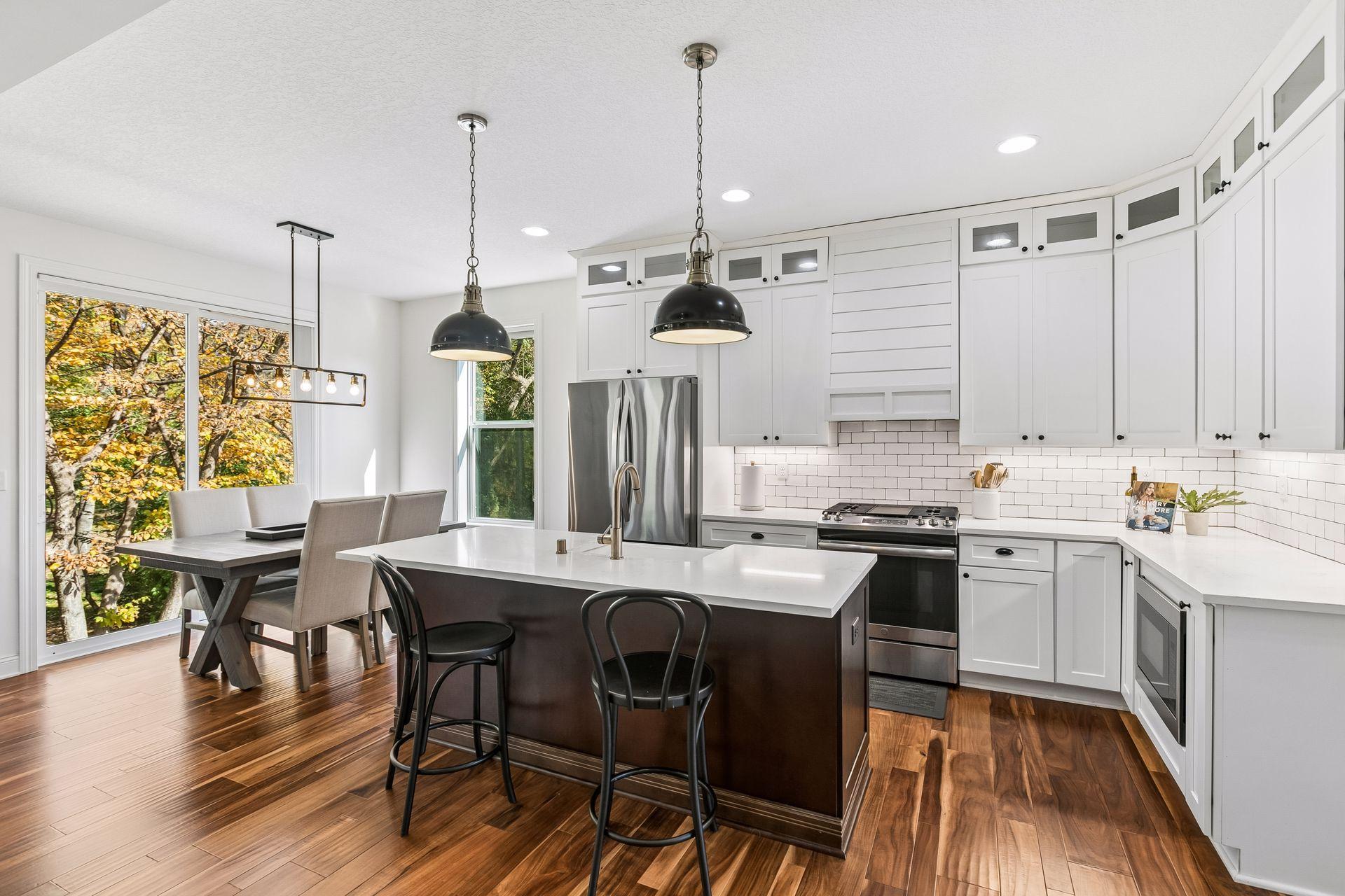 Beautiful white kitchen complemented by stainless steel appliances.