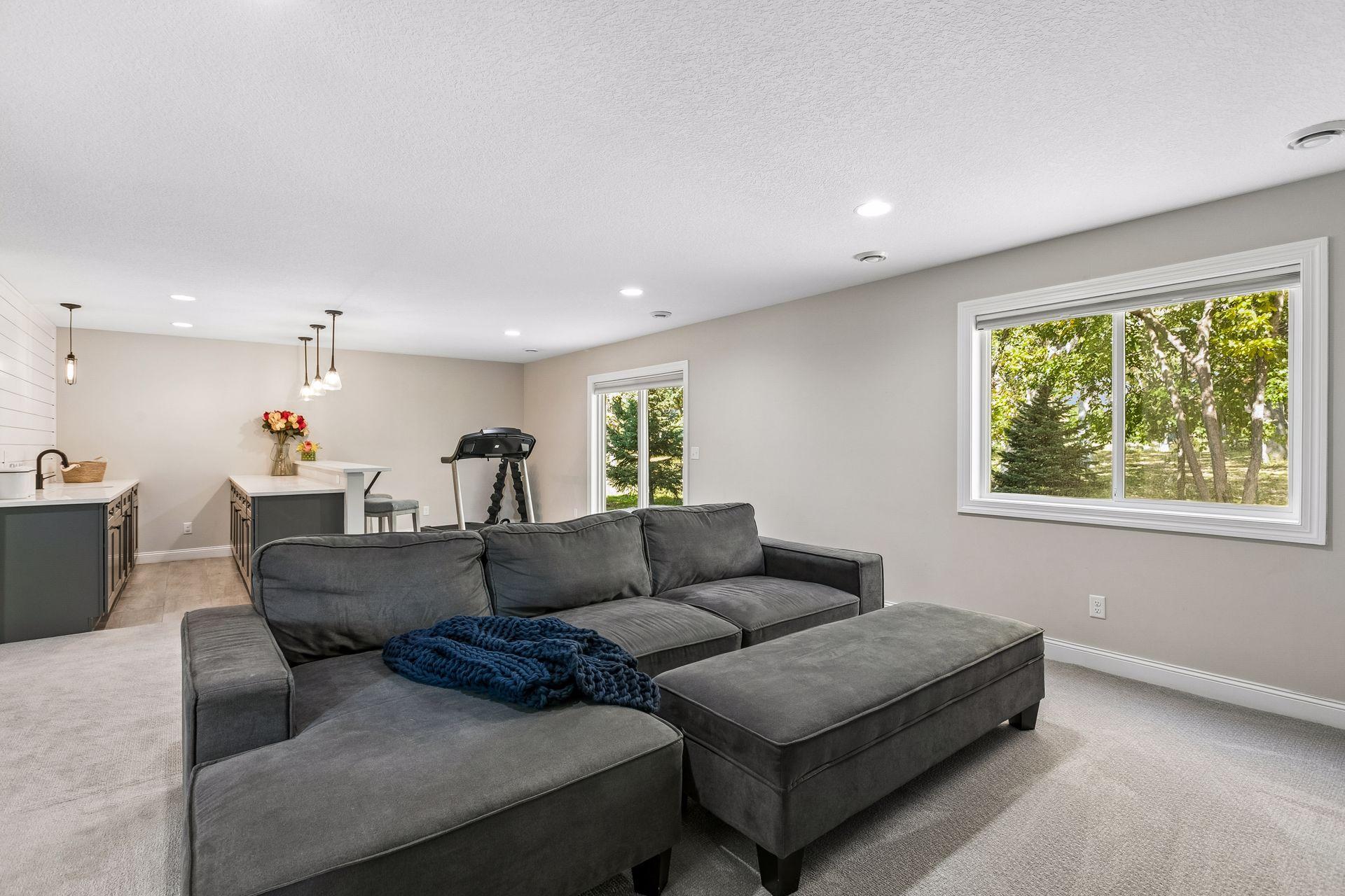 Spacious walkout lower-level family room offers an inviting space for entertaining.