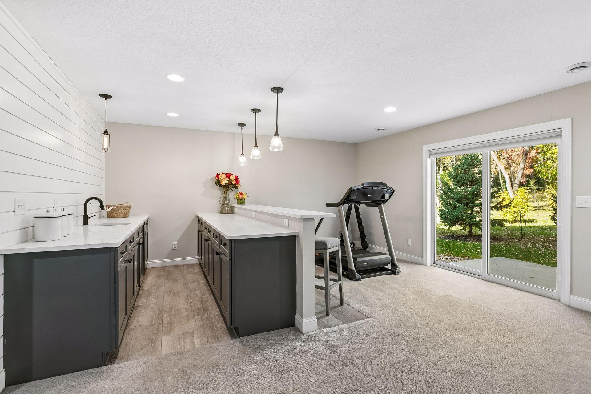 Lower-level bar area features sliding doors opening to the backyard.