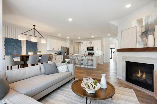 Come over to the living room perfect for any occasion! Both spacious and luxurious, this living room is perfect for any occasion! Photo of model home.