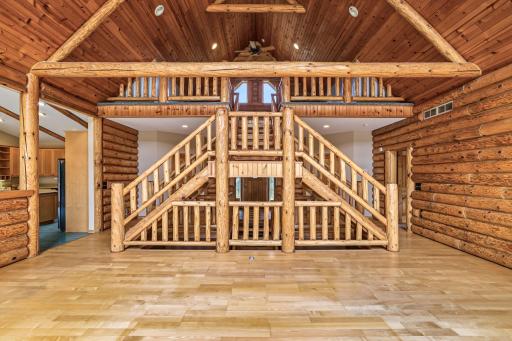 Exceptional craftsmanship is on display throughout the great room - a dramatic open log staircase, soaring wood ceilings, exposed beams, and an open loft create a timeless Northwoods retreat.
