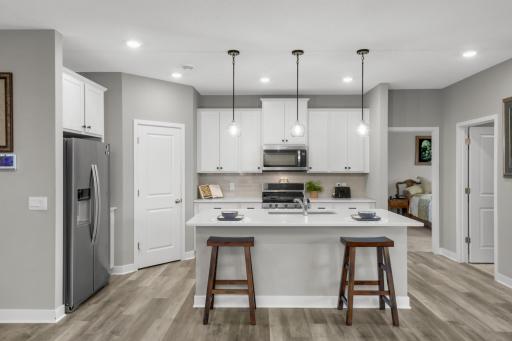 Large center island, stone countertops, ample cabinetry and tile backsplash!