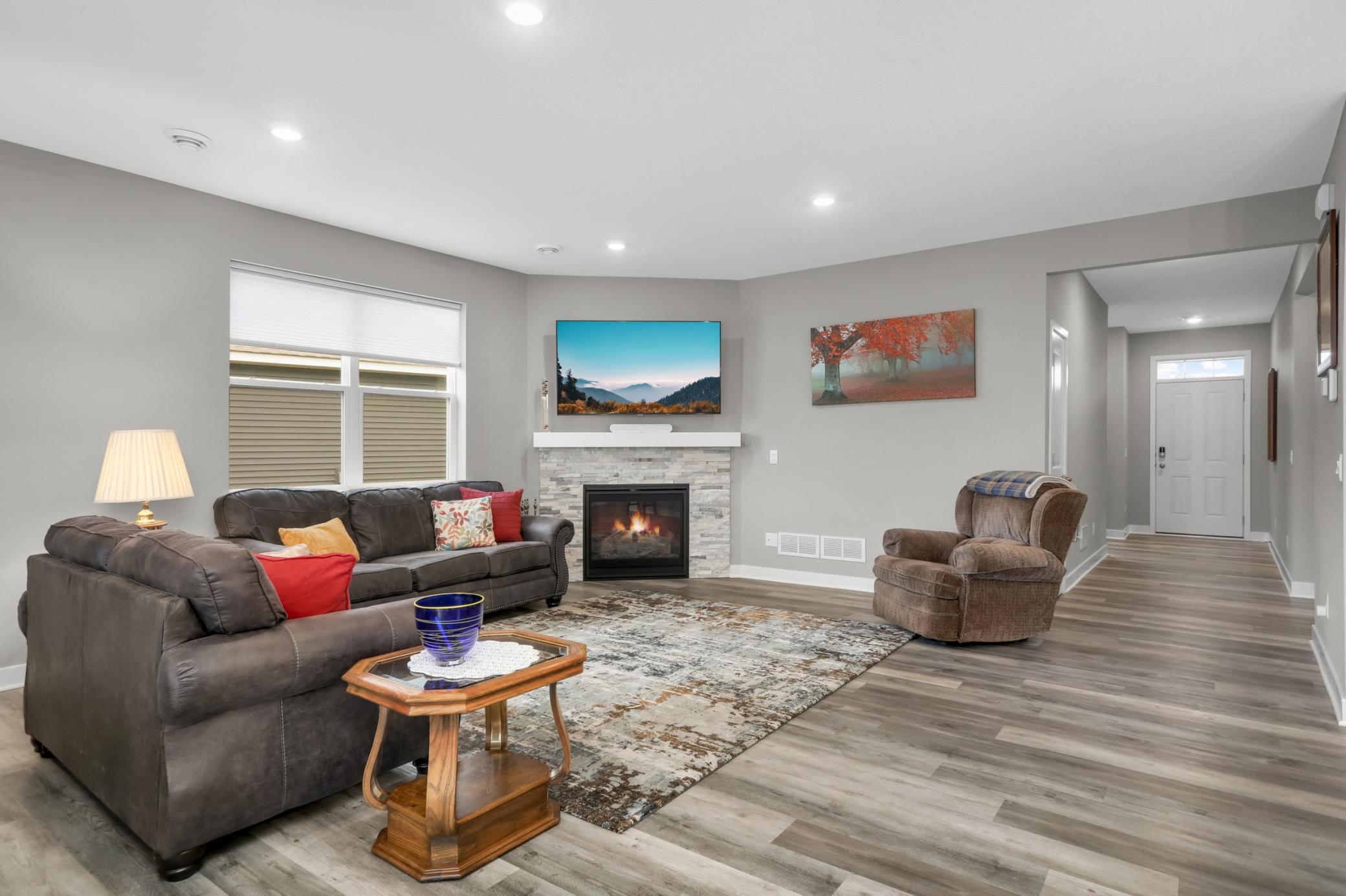 Large living room features a gas fireplace with stone surround.