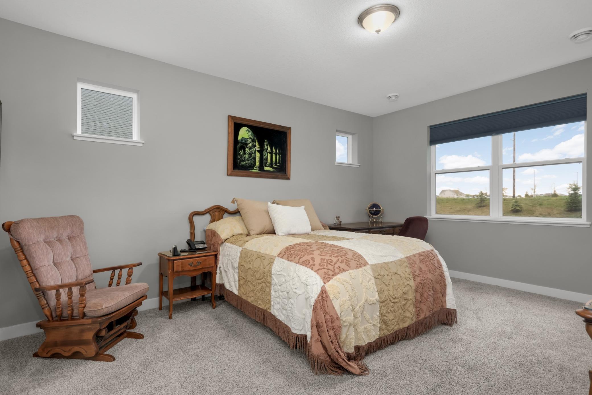 Primary bedroom is just off the main living areas with a view to the backyard.