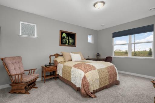 Primary bedroom is just off the main living areas with a view to the backyard.