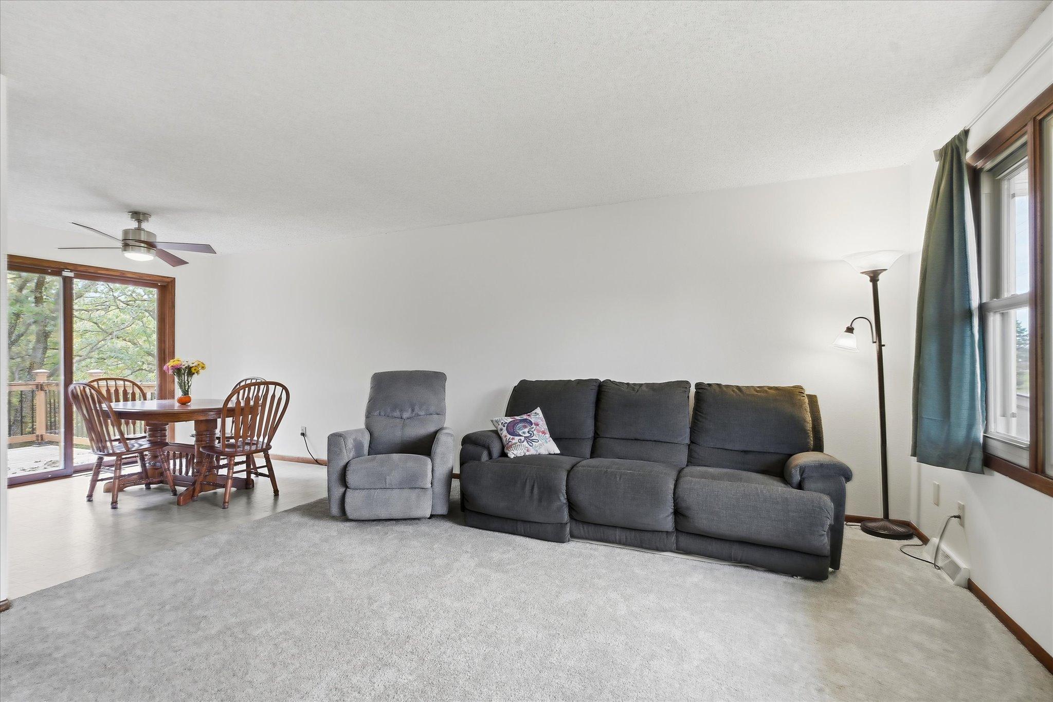 Open living and dining areas offer an easy flow for everyday living and entertaining, complemented by new carpet and access to the backyard deck.