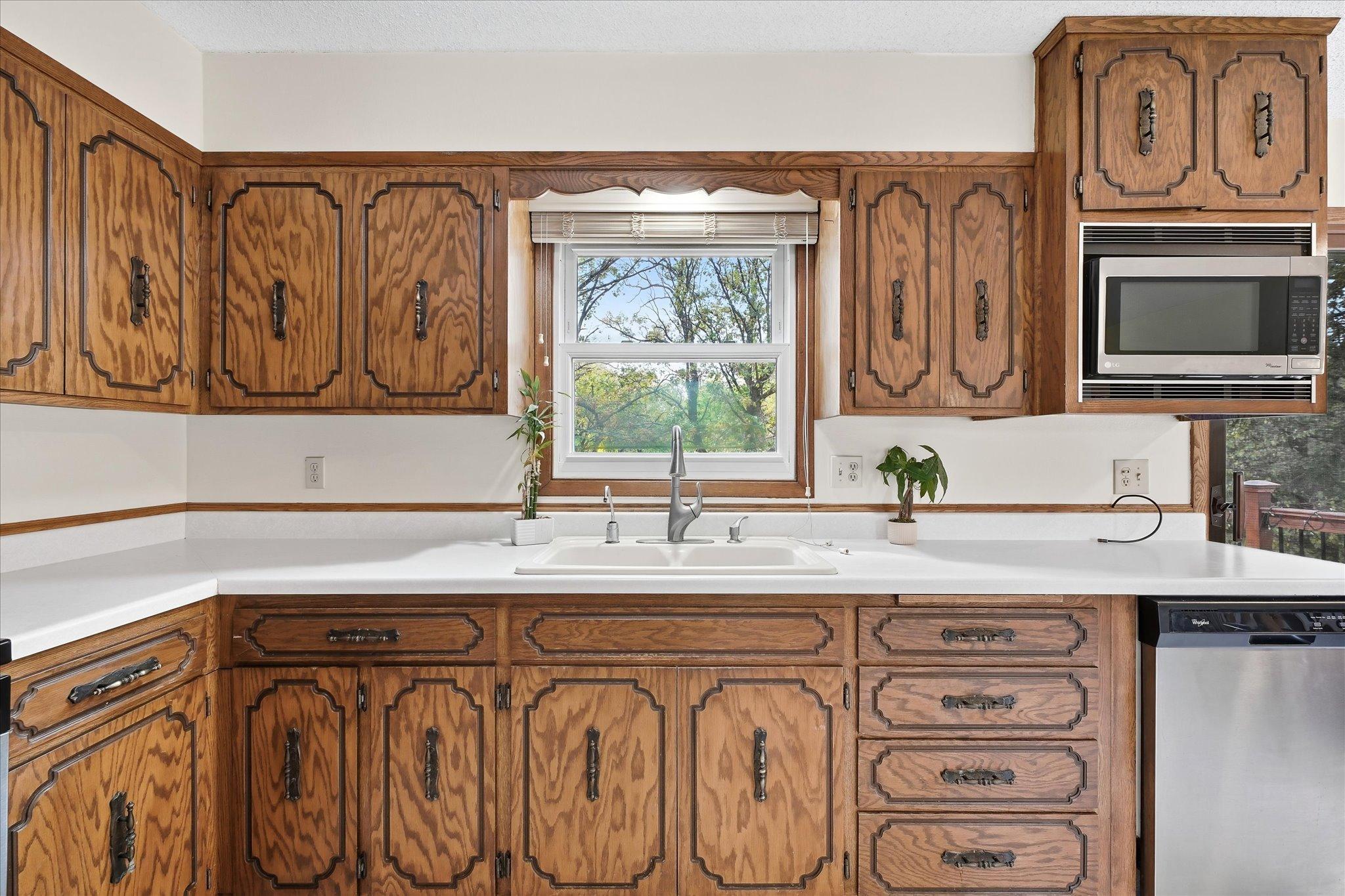 A large window bringing in natural light and providing beautiful views of the surrounding trees.