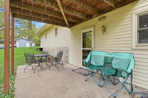 The lower-level kitchen and laundry area walks directly out to a private covered patio overlooking the tree-filled backyard.