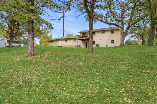 Spacious backyard with plenty of open lawn surrounded by mature trees, creating a peaceful setting with room to enjoy the outdoors.