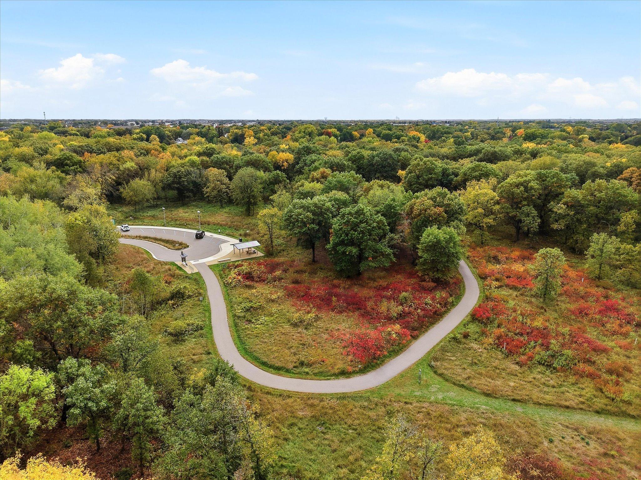 This aerial perspective captures the home tucked alongside the wooded landscape of Bridgeview Park Reserve, offering a unique combination of neighborhood living and nearby nature.