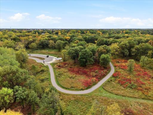 This aerial perspective captures the home tucked alongside the wooded landscape of Bridgeview Park Reserve, offering a unique combination of neighborhood living and nearby nature.