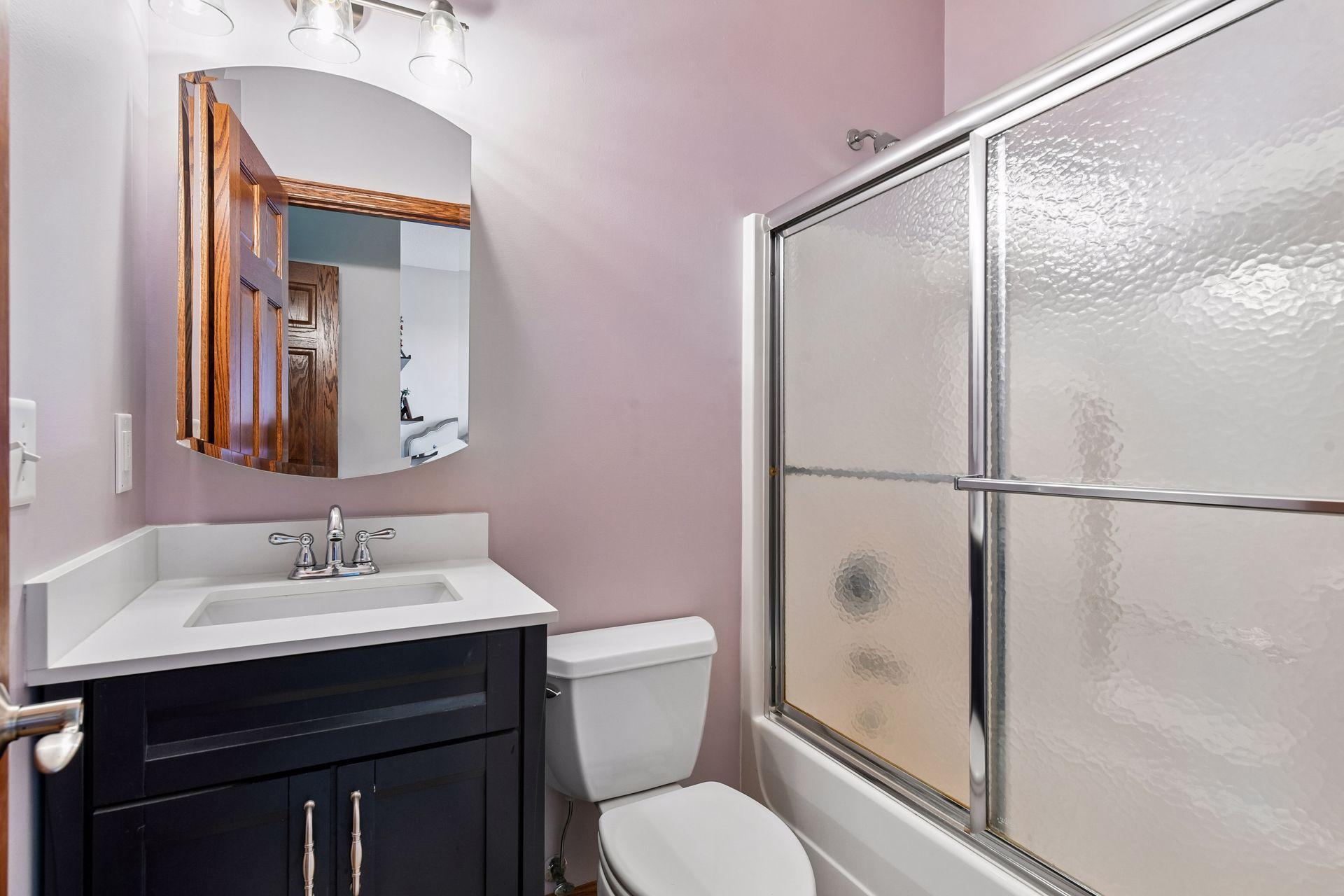 The full ensuite bathroom features a furniture-style vanity and a large walk-in closet.