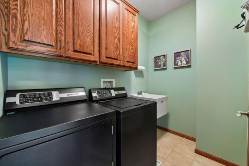 Conveniently located on the upper level, the Laundry Room offers tiled flooring, a laundry sink and cabinetry. Please note the washer and dryer will not convey.