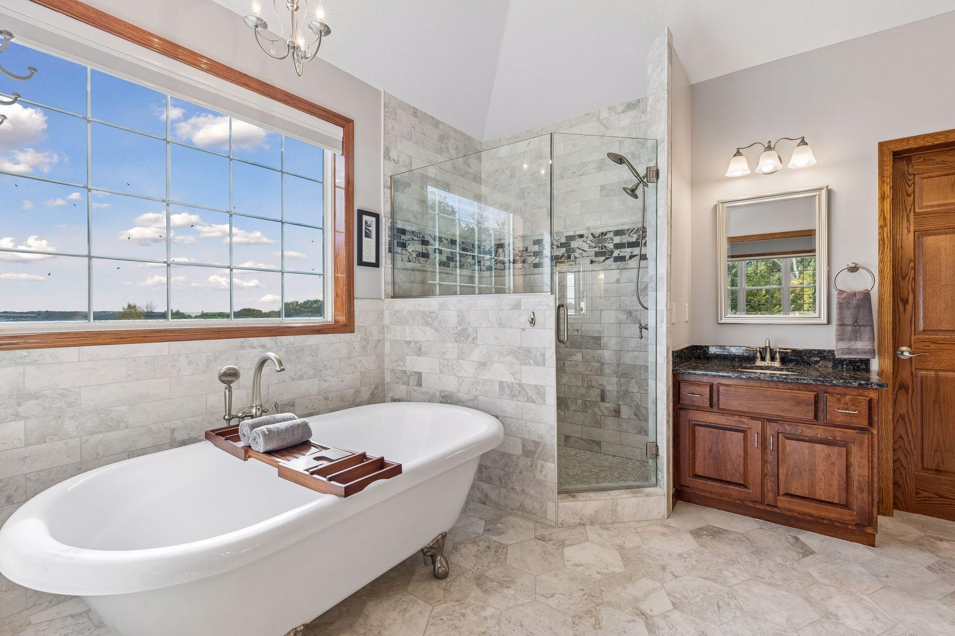 French doors open into the Primary Bathroom, where you will find heated tiled flooring, a timeless clawfoot bathtub and luxurious tiled shower.