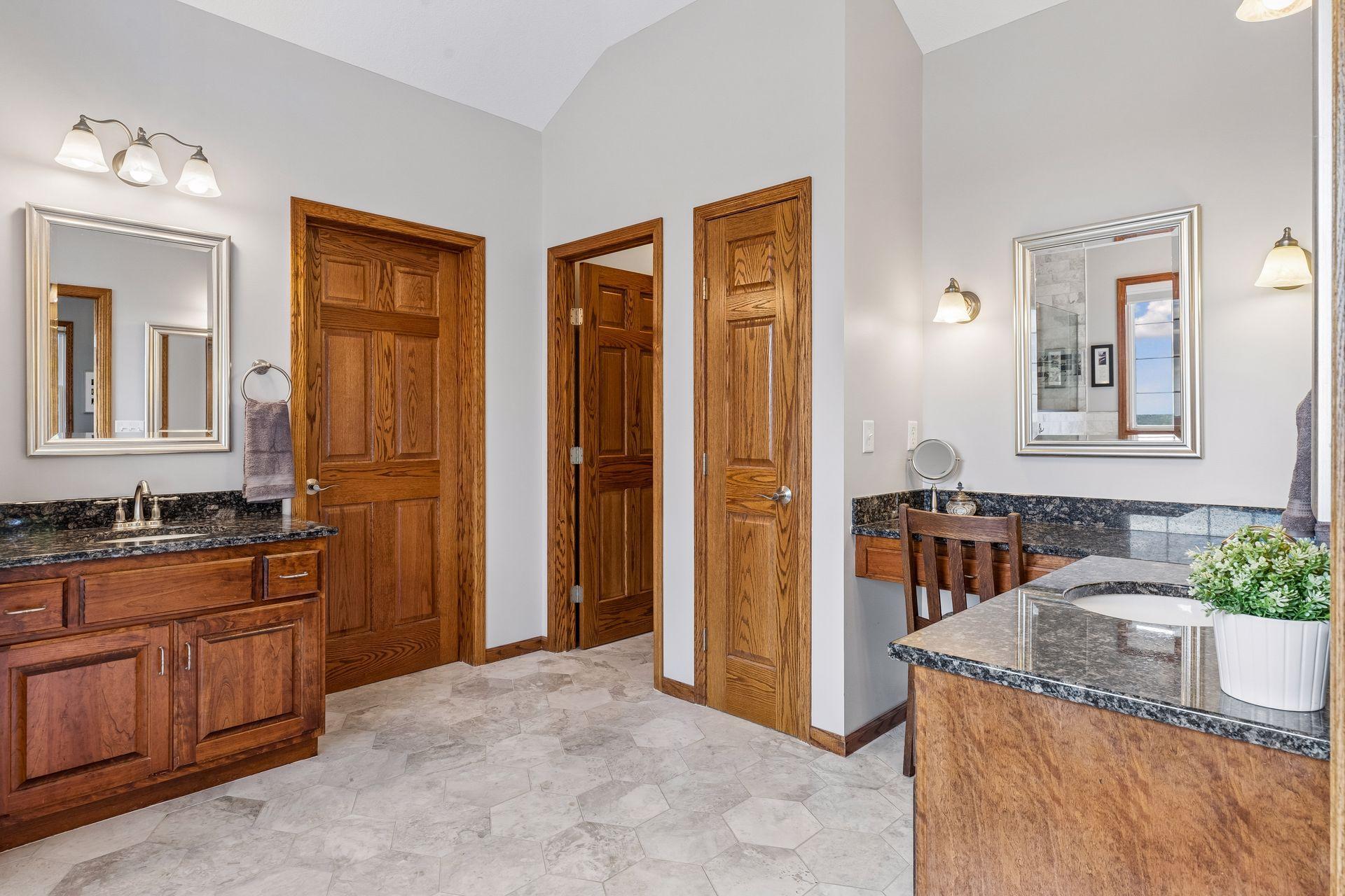 The Primary Bathroom features separate vanities with granite countertops and a linen closet.