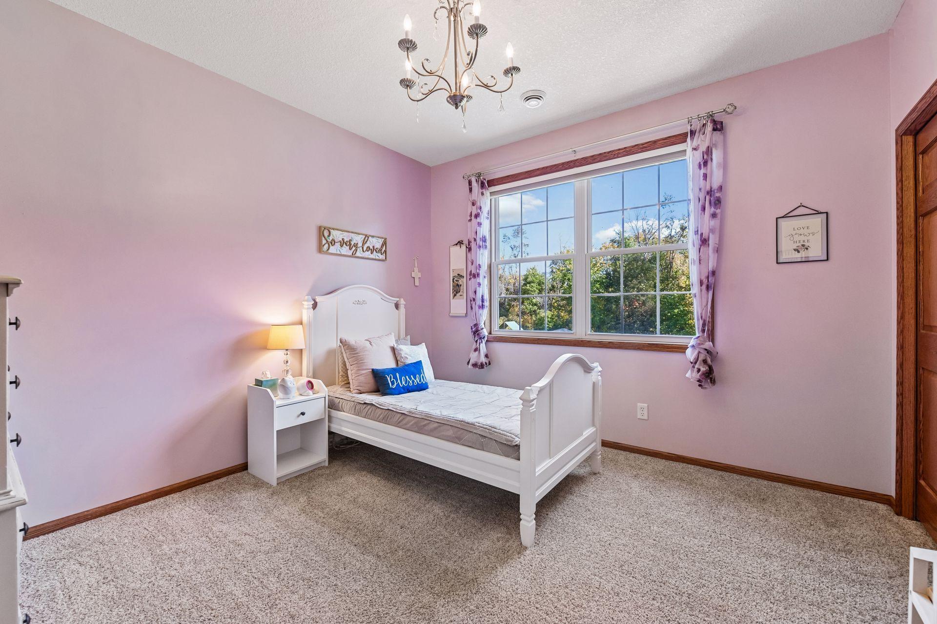 This inviting bedroom overlooks the backyard and features an extra wide closet with built-in shelving.