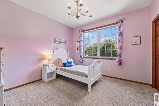 This inviting bedroom overlooks the backyard and features an extra wide closet with built-in shelving.