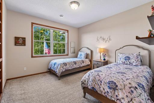 In addition to the Primary Suite, there are three Junior Bedrooms located on the upper level. This bedroom is a private suite with a built-in bookcase.